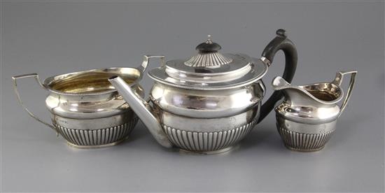 A Victorian three piece demi-fluted silver oval tea set by Stephen Smith, gross 33 oz.